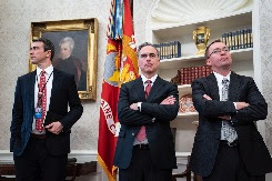 3 men in suits in the Oval Office